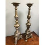 A Large pair of heavy brass ornate candle sticks. Measure 61cm in height.