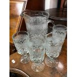 Heavy pressed glass jug & 4 goblets.