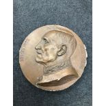 A Large Bronzed plaster memorial wall plaque coin. Measures 40cm in diameter. Signed by the artist.