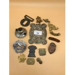 A Tub full of mixed military cap badges, buckles and thistle design plaque