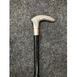 A Silver topped walking stick/ cane. The shaft is made from ebony. Measures 92cm in length.