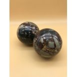 Two Antique granite balls/boules. Measure 8cm in height.