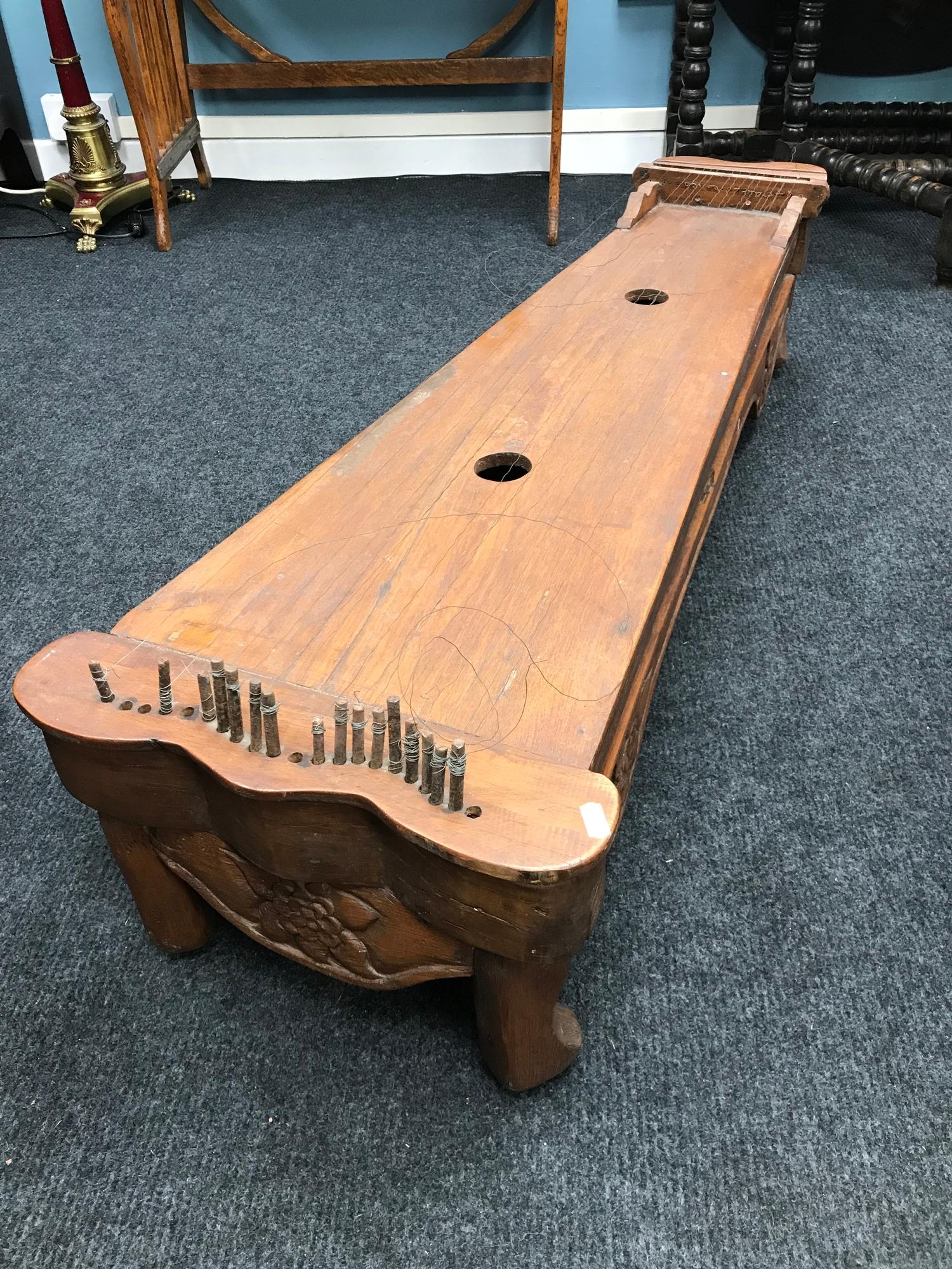 A Large 19th Century Malaysian hardwood Zither/ Guqin sit down instrument. Comes with wooden tone/
