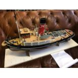 A Large hand made tug boat model. Highly detailed. displayed on a wooden display stand. made by