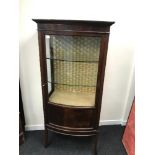 Antique pedestal bow front display cabinet. Fitted with glass front door and glass shelves. Measures