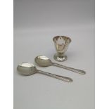 A Birmingham silver egg cup, together with two Sheffield silver teaspoons