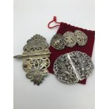 A collection of three arabic silver belt buckles