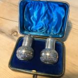 A pair of silver (London) pepper pots within a fitted case (Sibray, Hall & Co Ltd, 1901)