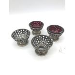 Four Victorian silver salt dishes (two complete with cranberry glass inserts), by George Angell &