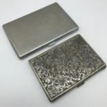 A 800 grade silver ornate cigarette case (11x8cm) together with a white metal case (13cmx9cm)