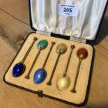 A set of silver (Birmingham) teaspoons with various coloured enamel backs, complete with original