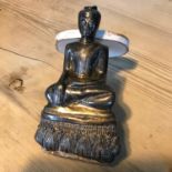 A 19th century weighted Thai Buddha with silver overlay. Measures 15cm in height