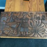 An early 1900's hand carved African tribal wall plaque, depicting two tribes at war, also showing