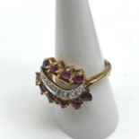 A 14ct gold ladies ring set with Diamonds and Ruby stones.