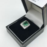 A 9ct gold ladies dress ring set in a square design, Centred with a large green stone squared off