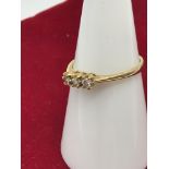 A 9ct gold ladies ring set with 3 diamond stones. Size M.