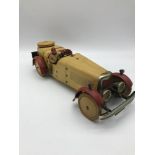 A 1930's Meccano racing car construction set. Made from tin plate. Cream body with red trims and