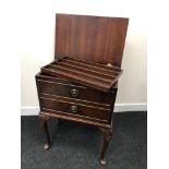 A One drawer sewing table with lift up lid and lift out shelf storage.