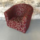 A contemporary tub chair by Marks & Spencers, with a floral design upholstery