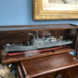 A Highly detailed naval battleship model with a wood and perspex case.