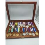 A collection of various military medals together with ribbons, within a presentation case