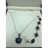 A Silver and blue hard stone bracelet and pendant set.