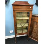 An Edwardian narrow display cabinet. Fitted with glass door and sides. Measures 160x60x34cm comes