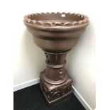 A Large heavy brown glazed stone pedestal plant stand.110CM. 57CM IN DIAMETER