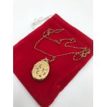 A 9CT Gold back and front ornate locket set with seed pearls and a ruby stone. Together with a 9ct