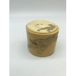 A Meiji period ivory lidded pot engraved with leopards. Measures 6cm in height