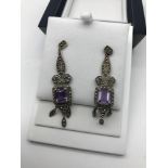 A Pair of silver Art Deco earrings set with Amethyst and Marcasite stones.