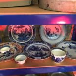 A shelf of oriental blue & white plates & bowls