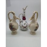 A pair of dragon handled jugs with hand painted detail to the sides depicting a cherub and lady