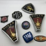 A Lot of vintage car badges which includes Jaguar, Rover and MG.