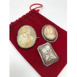 A Lot of 3 Victorian cameo brooches set in silver frames. Floral design brooch is Edinburgh silver.