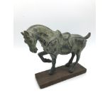 A Cold painted bronze Chinese Tang horse sat upon a hardwood base. Measures 16x20x6cm