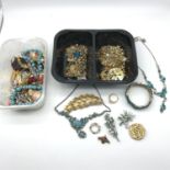 2 Tubs filled with vintage costume jewellery which includes brooches, bracelets, earrings and