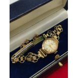 A 9ct gold cased Angus 21 Jewel ladies watch with rolled gold strap.