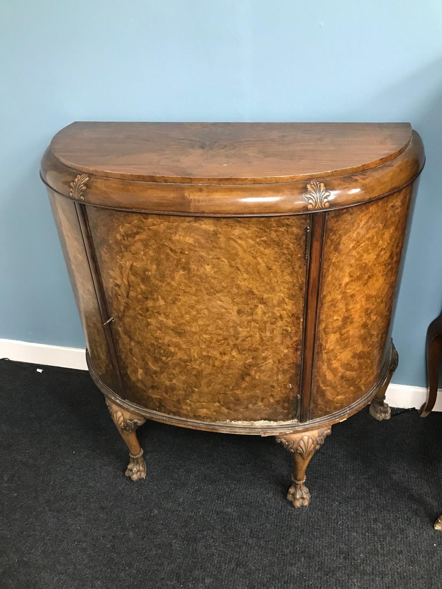 Antique Burr walnut demi loom half moon sideboard. Designed with claw feet. Comes with key. Measures