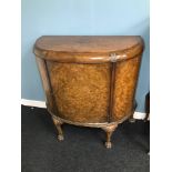 Antique Burr walnut demi loom half moon sideboard. Designed with claw feet. Comes with key. Measures