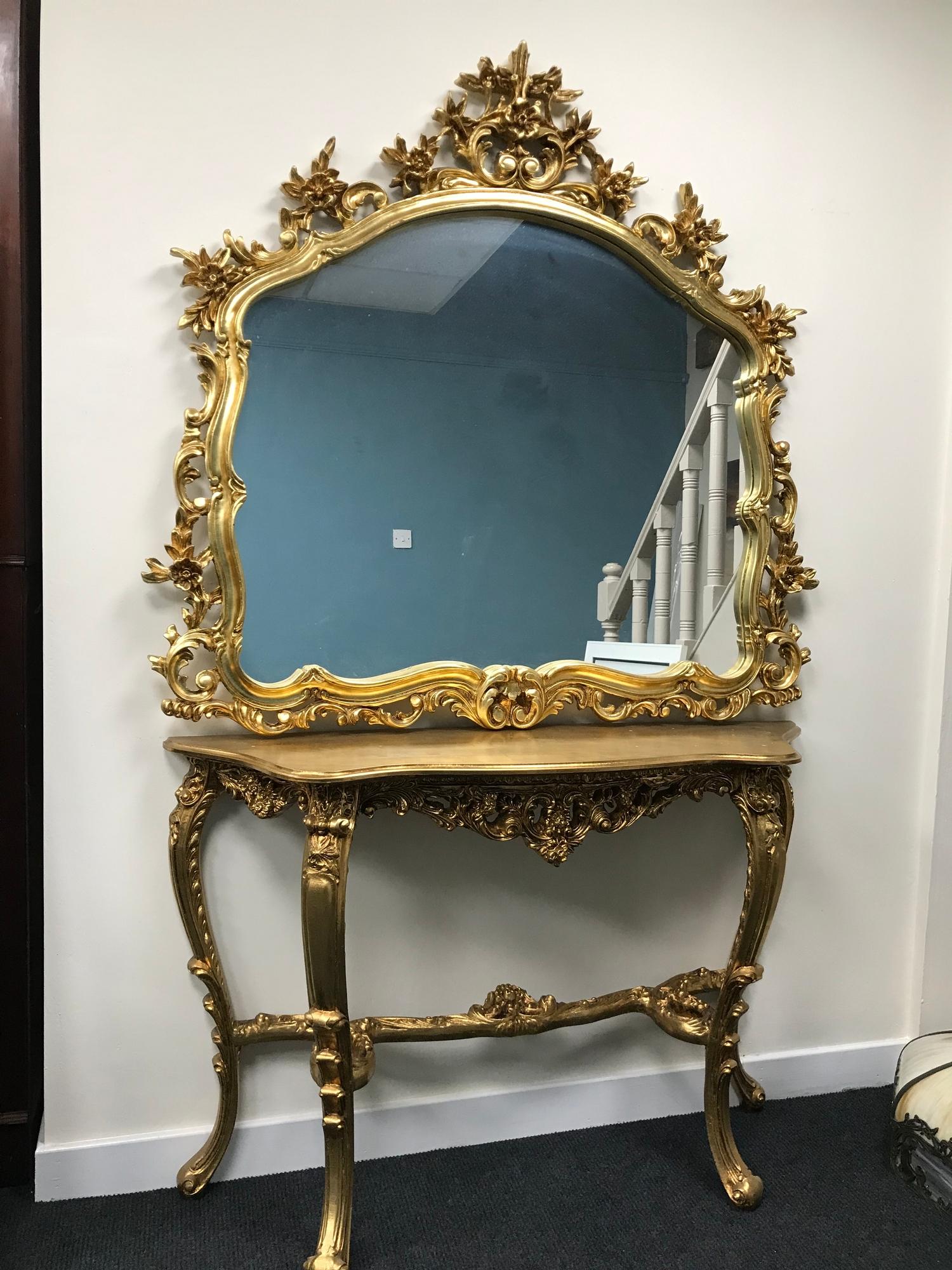 A highly decorative gilt table upon four cabriole legs (77.5x117x32cm), together with a flower and