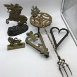 A Lot of arts and crafts brass kettle stands, Lion paperweight & Spelter and brass man on horse