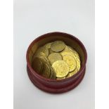 A Box filled with gold coloured Arabic token coins.