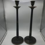 A Pair of oriental lacquered candle sticks. Measures 45.5cm in height.