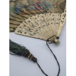 A Victorian fan designed with ivory and a hand painted design throughout the folds