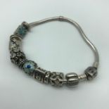 A genuine silver Pandora charm bracelet with various Pandora and Chamilia charms