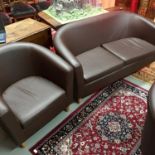 A Faux brown leather 2 seat couch and single tub chair.