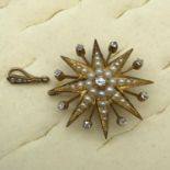 A Beautiful example of an Antique gold brooch/pendant in the shape of a star burst. The brooch is