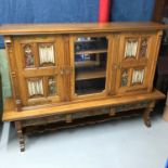 A Large Solid oak Renaissance style carved front 2 door, 2 drawer dresser. Detailed with colourful