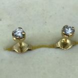 A Pair of 18ct gold and diamond stud earrings, .18ct of diamonds in each